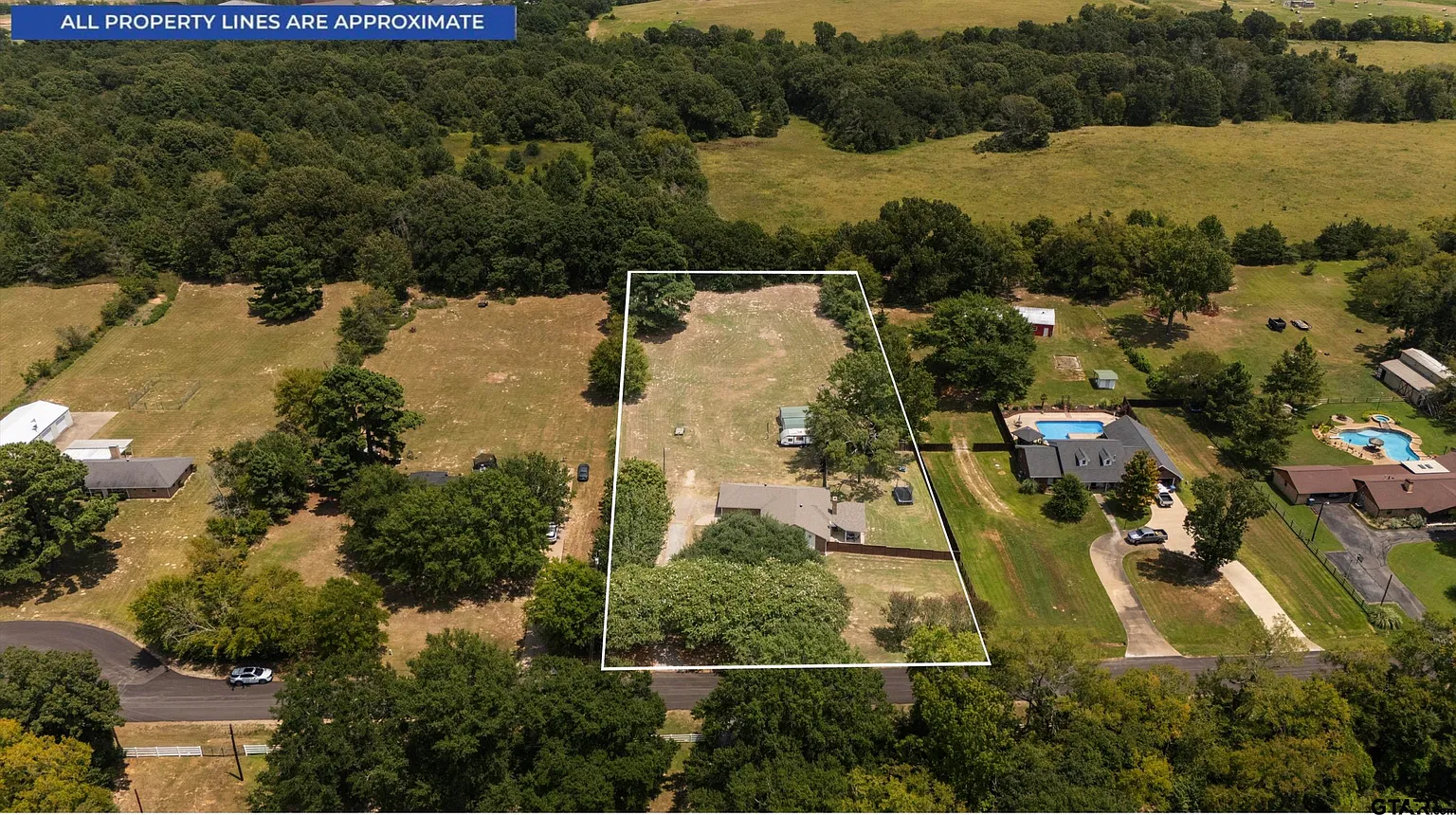Aerial view showing open land behind the home